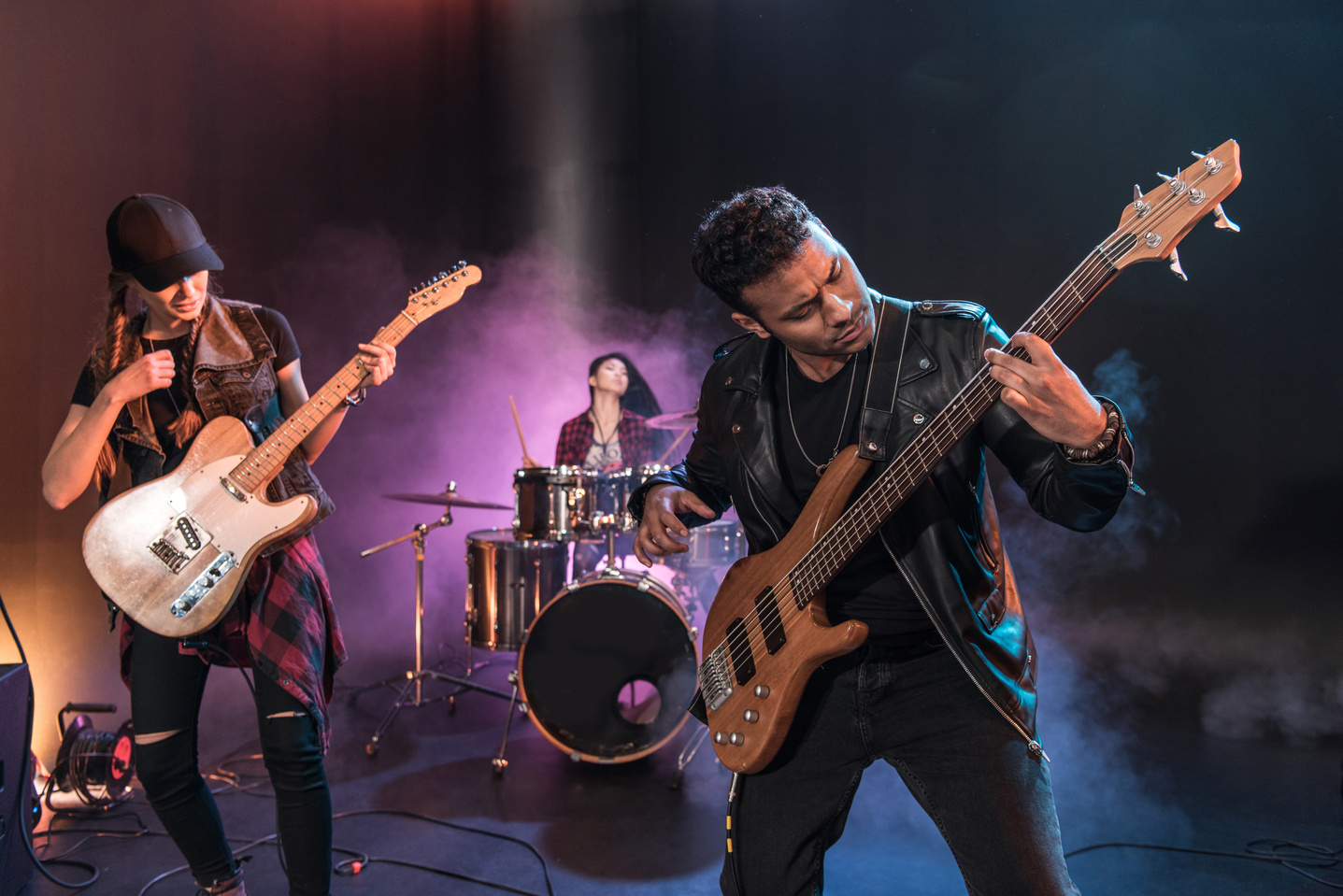 Rock and roll band with electric guitars playing hard rock music on stage